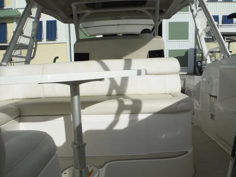 Slide: The Image of 2017 Everglades 360LXC boat interior with white seating and table. - 40