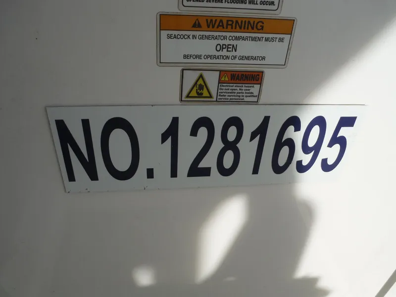 Slide: The Image of Warning signs and registration number on 2017 Everglades 360LXC boat. - 49