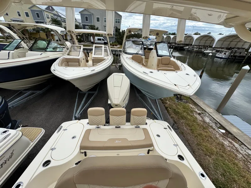 Slide: The Image of 2024 Scout 231 XSB boats docked at a marina, showcasing sleek design and luxury features. - 11