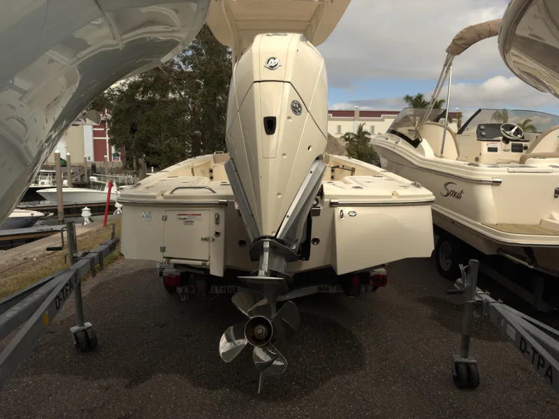 Slide: The Image of 2024 Scout 231 XSB boat with outboard motor, parked on a trailer. - 3