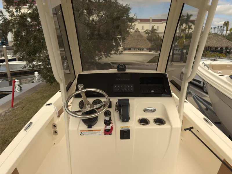 Slide: The Image of 2024 Scout 231 XSB boat console with steering wheel and controls. - 4