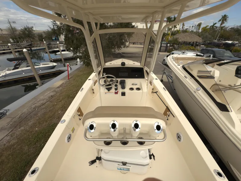 Slide: The Image of 2024 Scout 231 XSB boat interior with steering console and seating. - 5