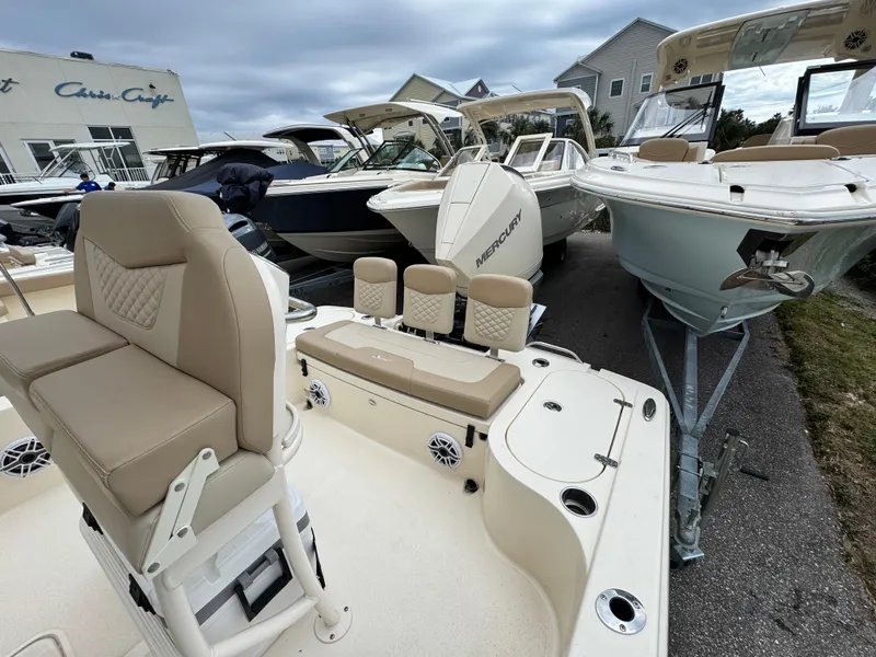 Slide: The Image of 2024 Scout 231 XSB boat with beige seating, displayed among other boats. - 9