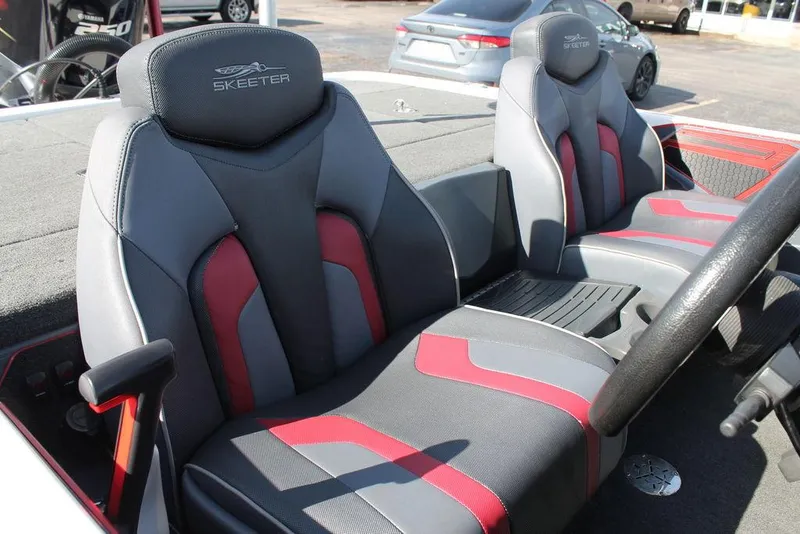 Slide: The Image of 2019 Skeeter FX21 Apex boat seats with red and gray design. - 11