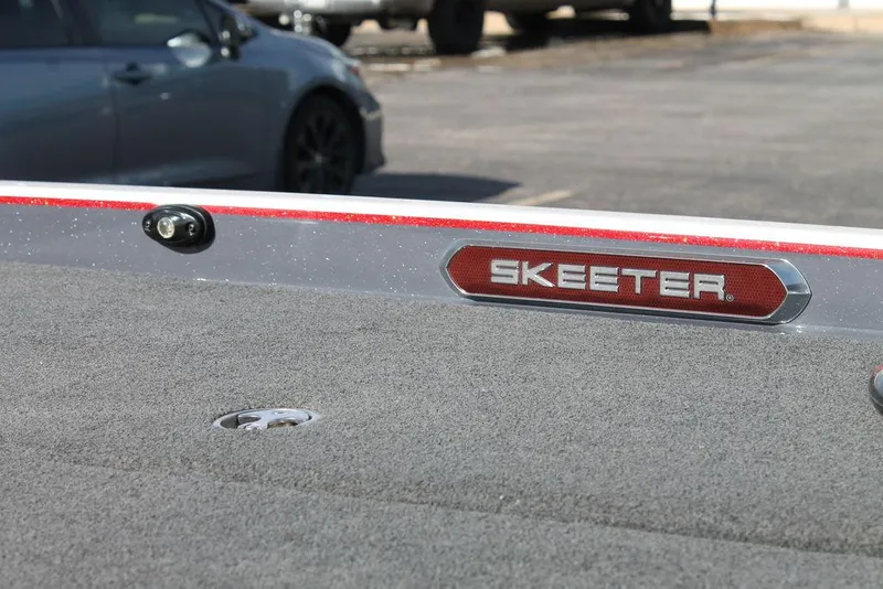 Slide: The Image of 2019 Skeeter FX21 Apex boat deck with logo in parking lot. - 12