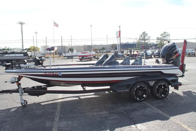 Slide: The Image of 2019 Skeeter FX21 Apex bass boat in a parking lot, side view. - 4