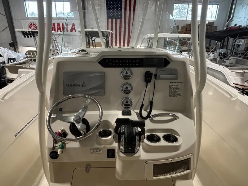 Slide: The Image of 2018 Sailfish 270 CC boat console with Garmin navigation, steering wheel, and controls. - 4