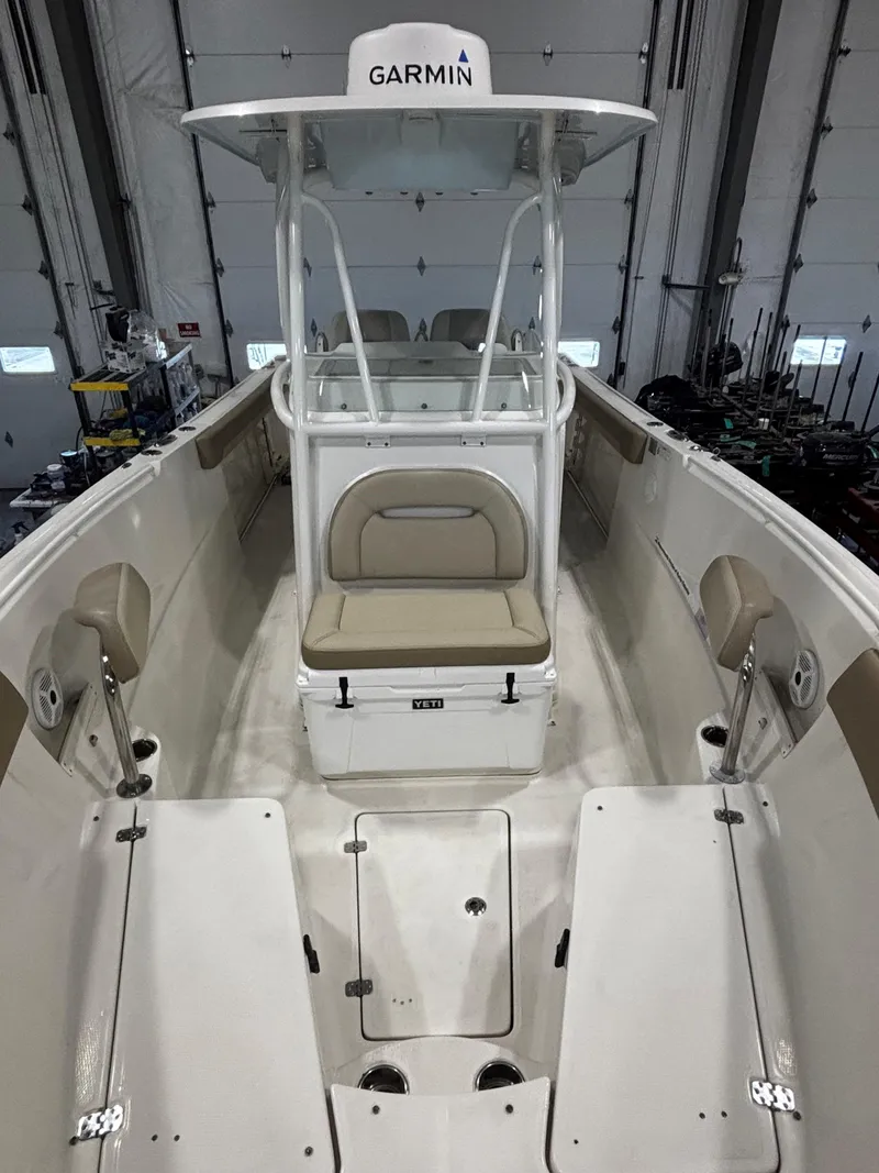 Slide: The Image of 2018 Sailfish 270 CC boat interior with Garmin equipment, featuring seating and storage. - 7