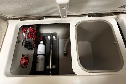 Slide: The Image of 2017 Cobalt R3 WSS Surf boat storage compartment with fire extinguisher and wiring. - 10