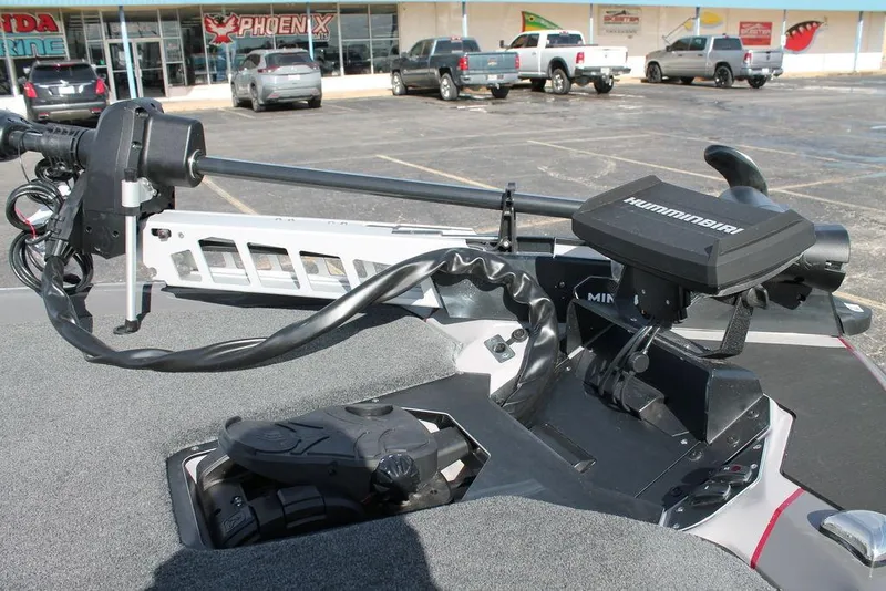 Slide: The Image of 2025 Skeeter ZXR21 boat with Minn Kota trolling motor in parking lot. - 10