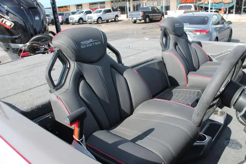 Slide: The Image of 2025 Skeeter ZXR21 boat interior with sleek black seats and red accents. - 11