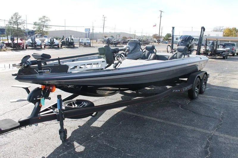 Slide: The Image of 2025 Skeeter ZXR21 fishing boat on trailer in parking lot. - 5