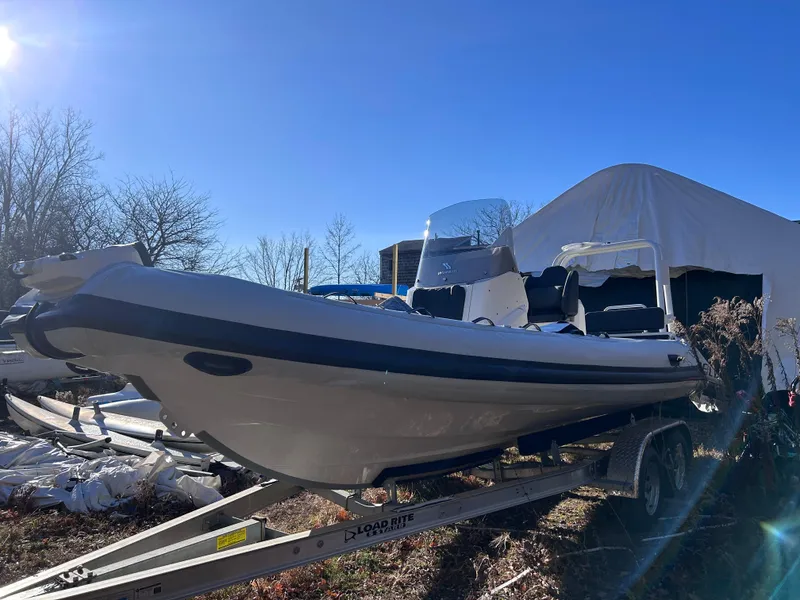 Slide: The Image of 2023 Highfield Sport 700 boat on trailer under clear blue sky. - 3