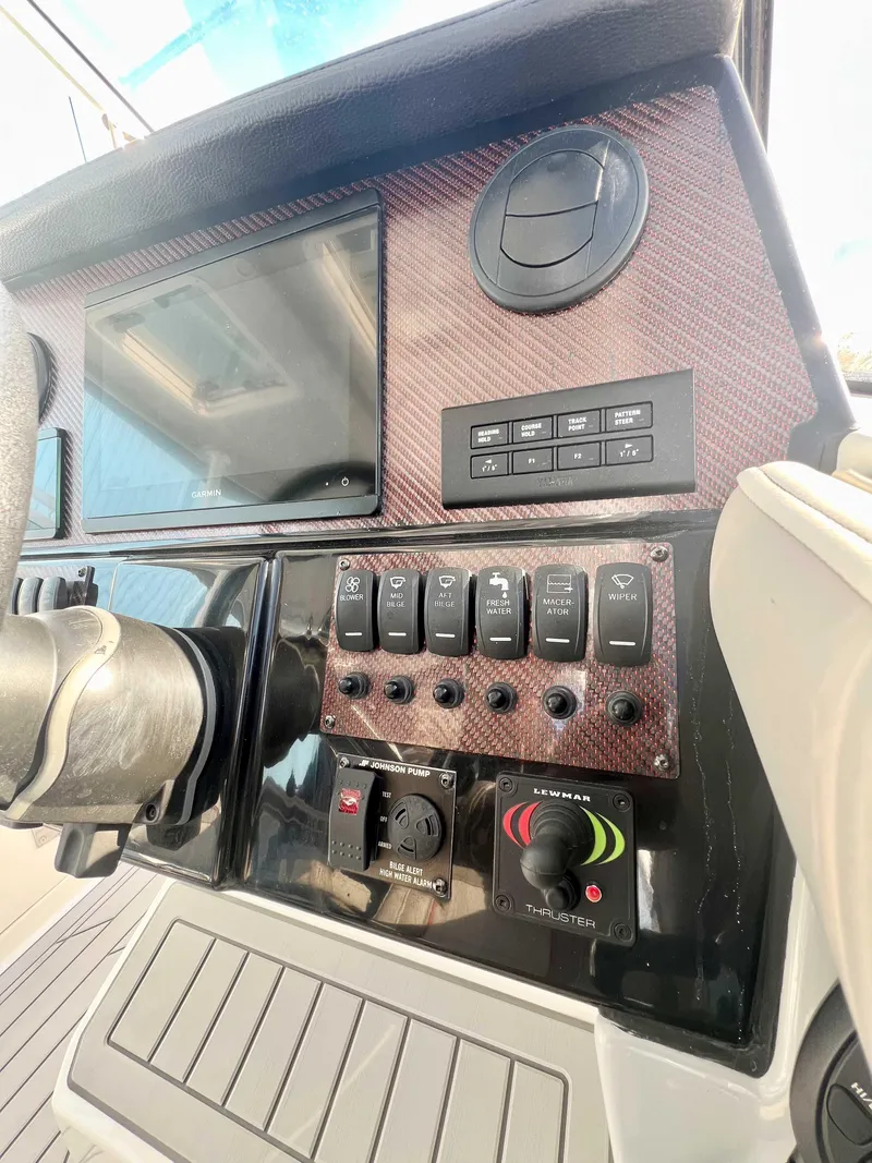 Slide: The Image of 2023 Solara S-250 DC boat dashboard with control panel and switches. - 11