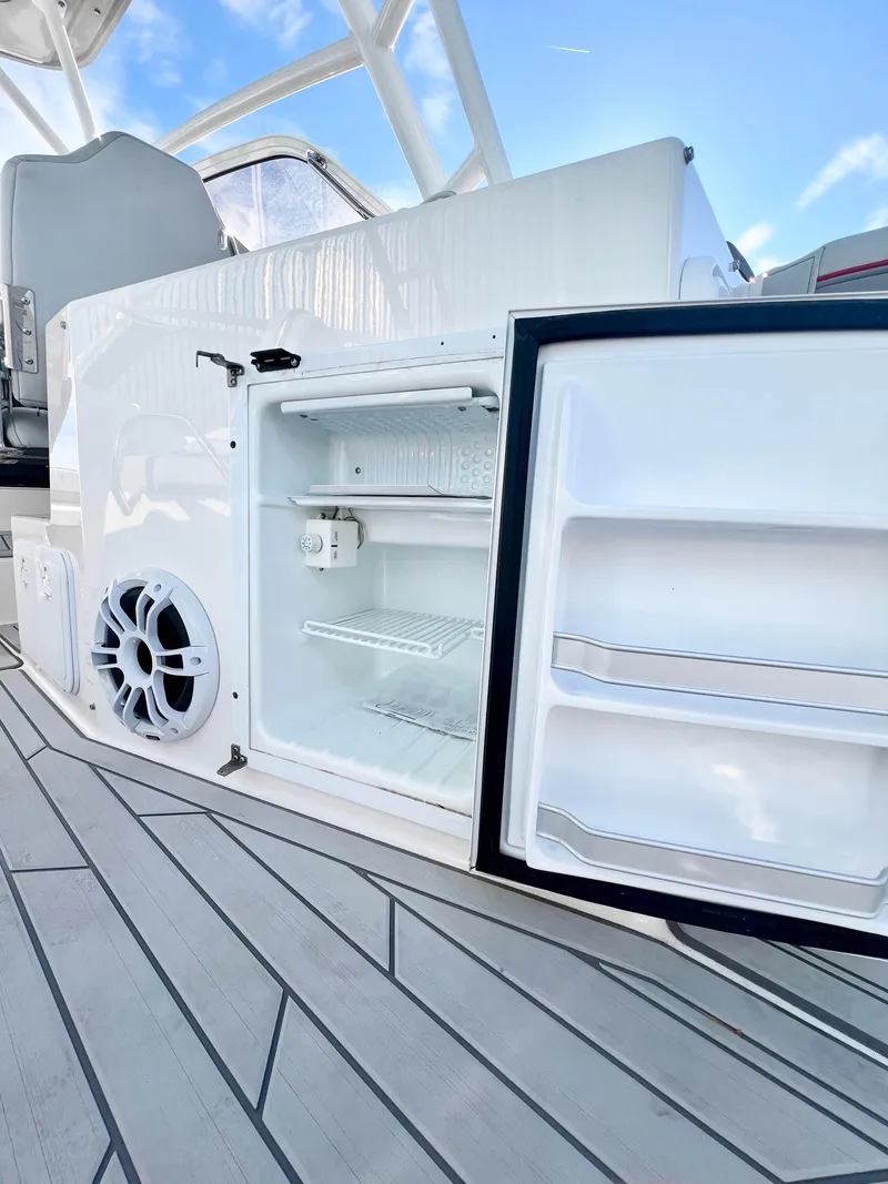 Slide: The Image of 2023 Solara S-250 DC boat interior with open mini fridge and speaker. - 15