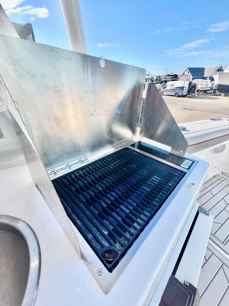 Slide: The Image of 2023 Solara S-250 DC boat grill with stainless steel cover on deck. - 17