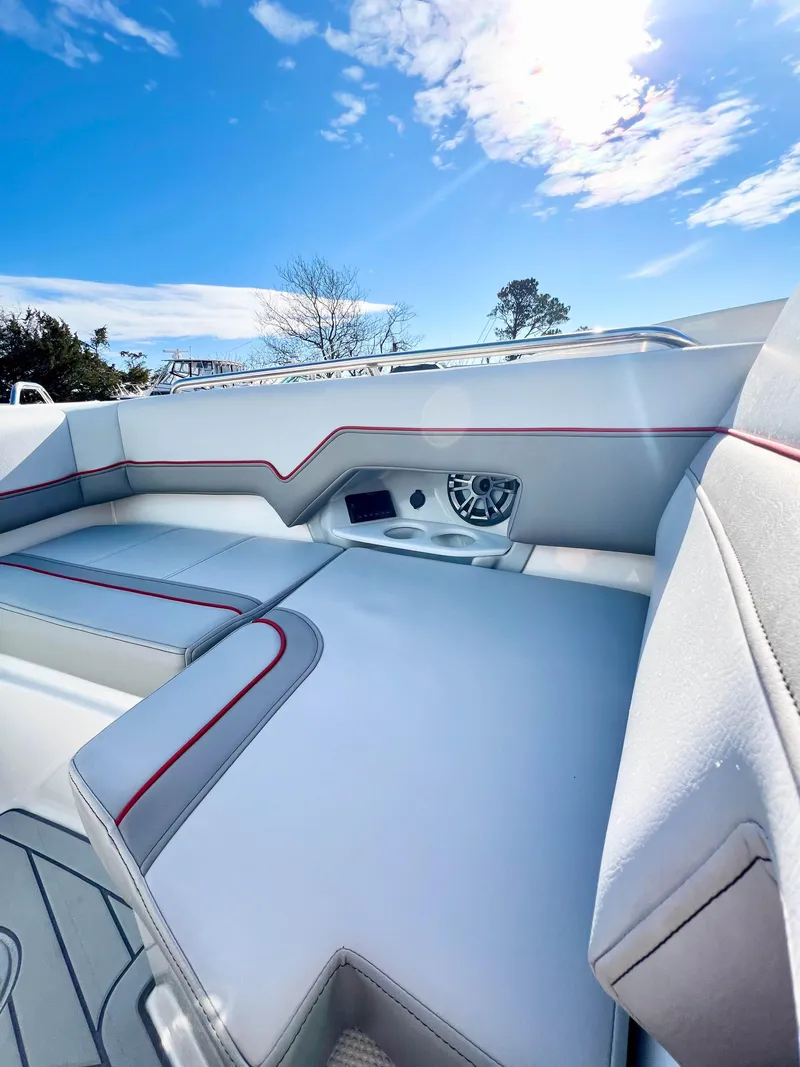 Slide: The Image of 2023 Solara S-250 DC boat interior with sleek seating and modern design under a clear blue sky. - 27
