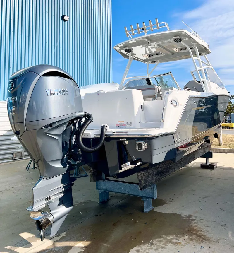 Slide: The Image of 2023 Solara S-250 DC boat with Yamaha outboard motor, docked outdoors. - 3