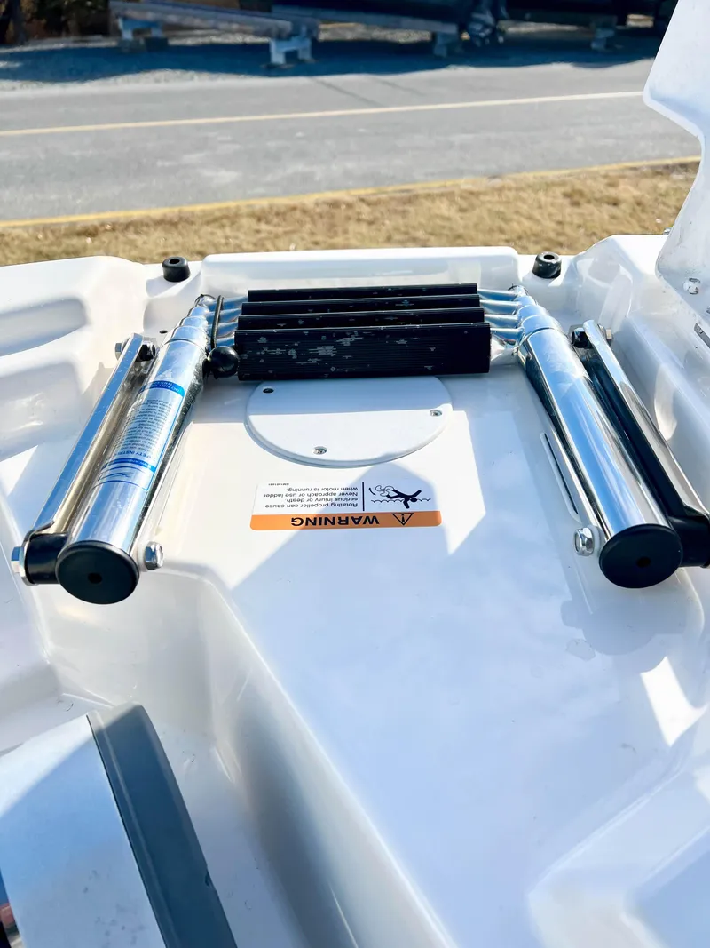 Slide: The Image of 2023 Solara S-250 DC boat ladder with warning label, chrome finish. - 31