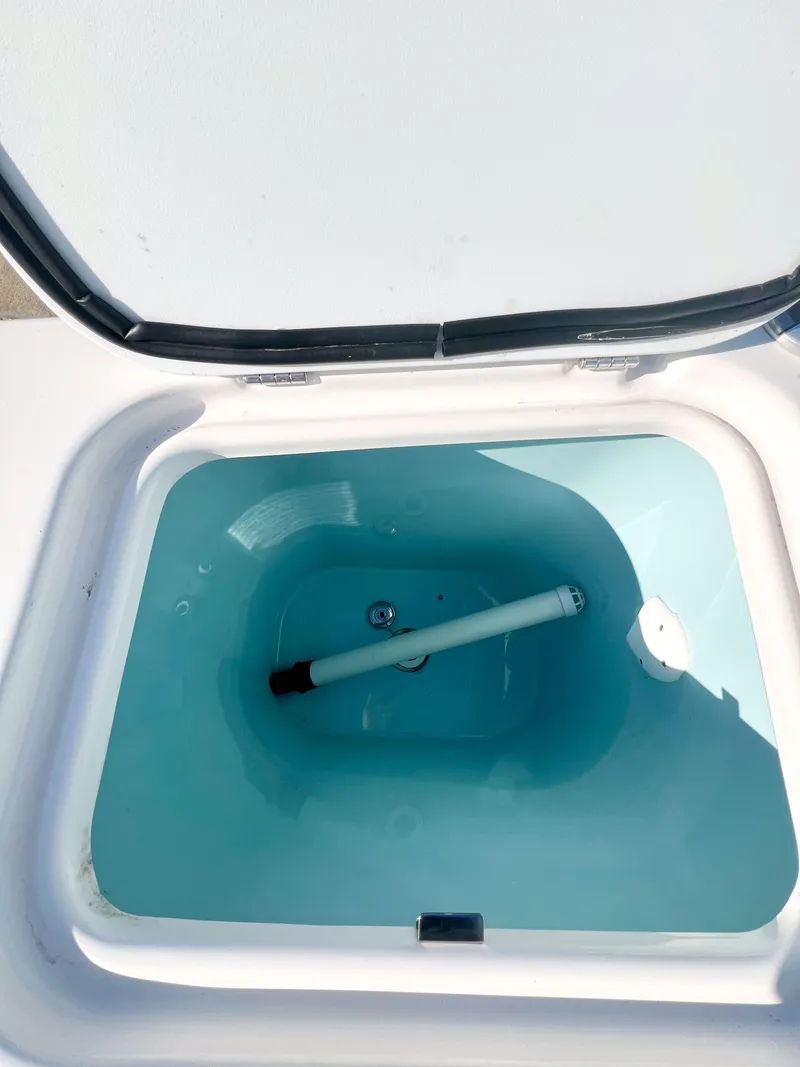 Slide: The Image of Open compartment of 2023 Solara S-250 DC boat, showing interior storage space. - 34