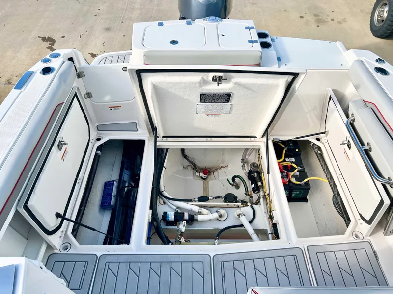 Slide: The Image of 2023 Solara S-250 DC boat engine compartment with open hatches and visible wiring. - 35