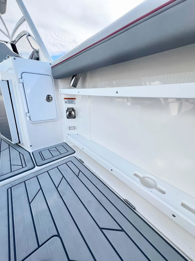 Slide: The Image of 2023 Solara S-250 DC boat interior with sleek flooring and storage compartment. - 37