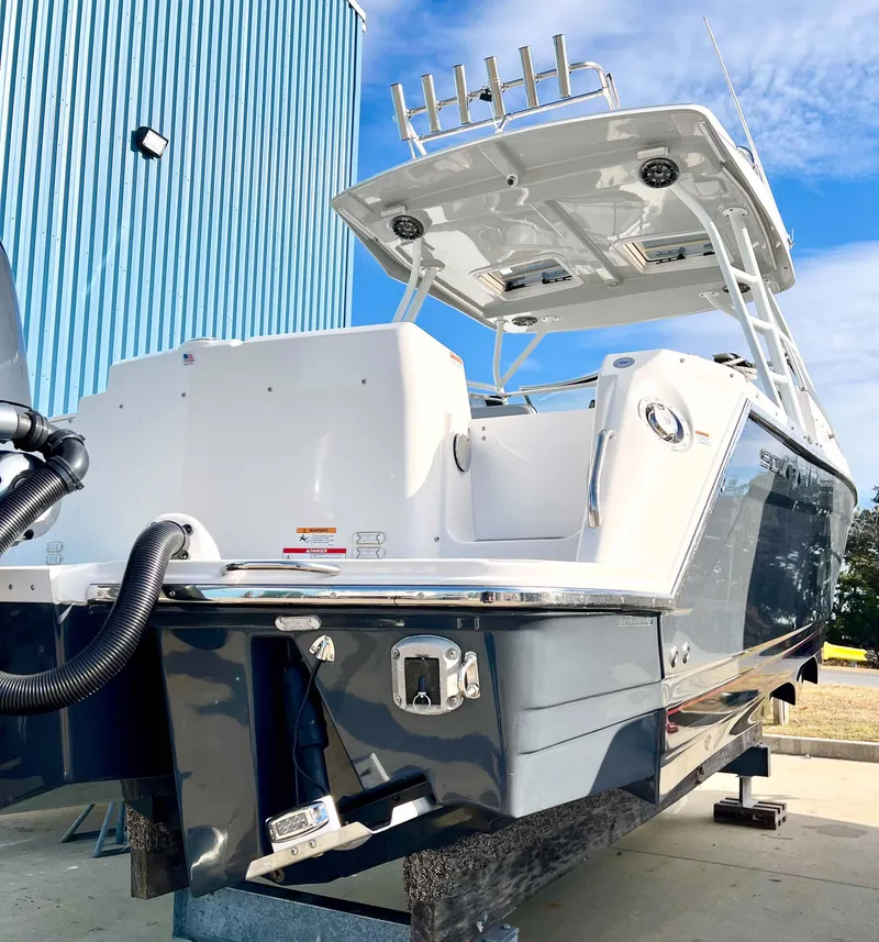 Slide: The Image of 2023 Solara S-250 DC boat with sleek design, docked outdoors. - 6