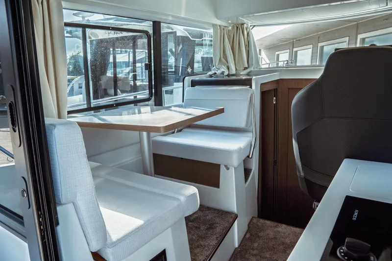 Slide: The Image of Interior of 2025 Jeanneau NC 895 Sport Series 2, featuring seating and dining area. - 19