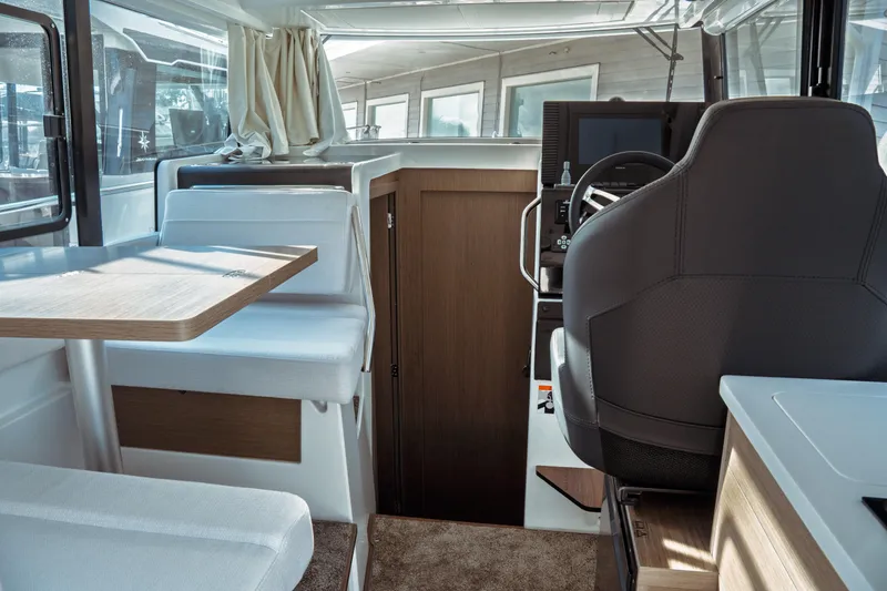 Slide: The Image of Interior of 2025 Jeanneau NC 895 Sport Series 2, featuring helm and seating area. - 20