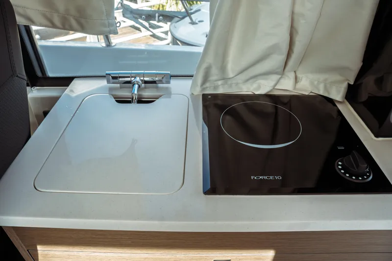 Slide: The Image of 2025 Jeanneau NC 895 Sport Series 2 kitchen with sink and Force 10 cooktop. - 23