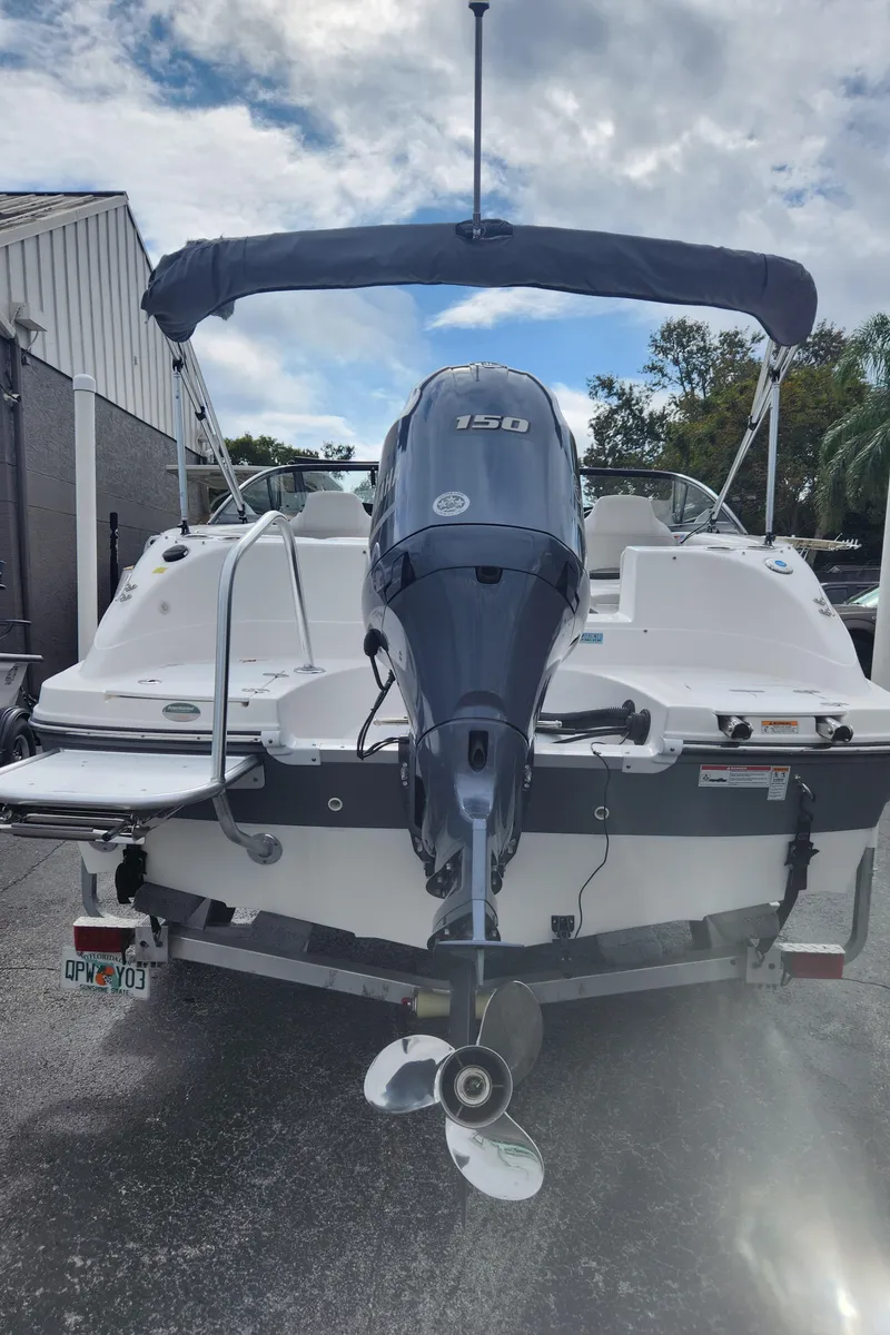 Slide: The Image of 2021 Hurricane SD 191 OB boat with outboard motor, parked outdoors. - 2