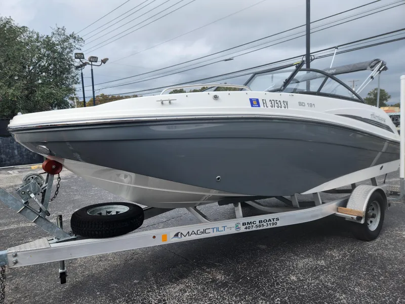 Slide: The Image of 2021 Hurricane SD 191 OB boat on trailer, gray and white design, parked outdoors. - 5