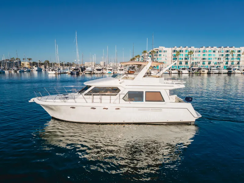Slide: The Image of 2007 Navigator Pilothouse yacht docked in a marina with clear blue skies. - 1