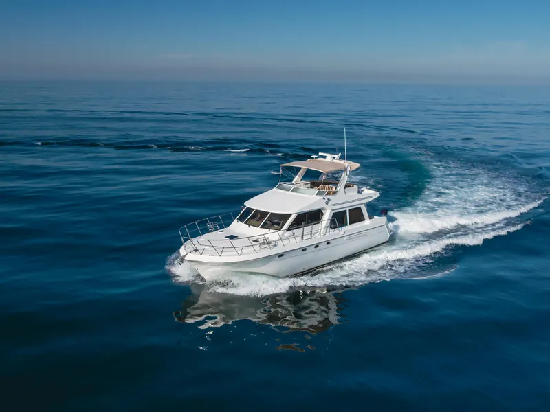 Slide: The Image of 2007 Navigator Pilothouse yacht cruising on open sea under clear blue sky. - 14