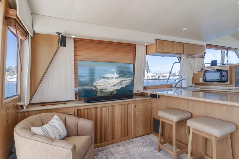 Slide: The Image of Interior of 2007 Navigator Pilothouse yacht with modern furnishings and large windows. - 16