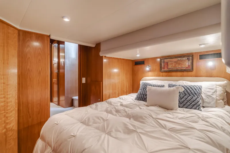 Slide: The Image of Luxurious bedroom in 2007 Navigator Pilothouse yacht with wood paneling and cozy bedding. - 25