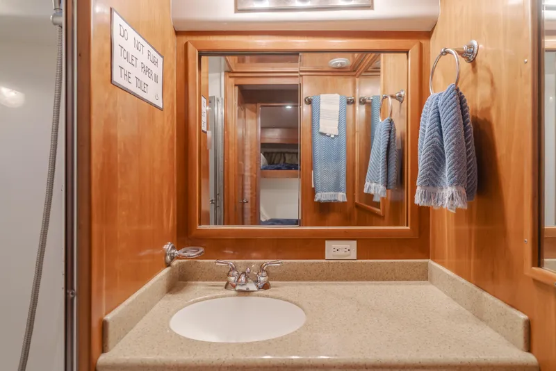 Slide: The Image of 2007 Navigator Pilothouse bathroom with wooden cabinetry and blue towels. - 27