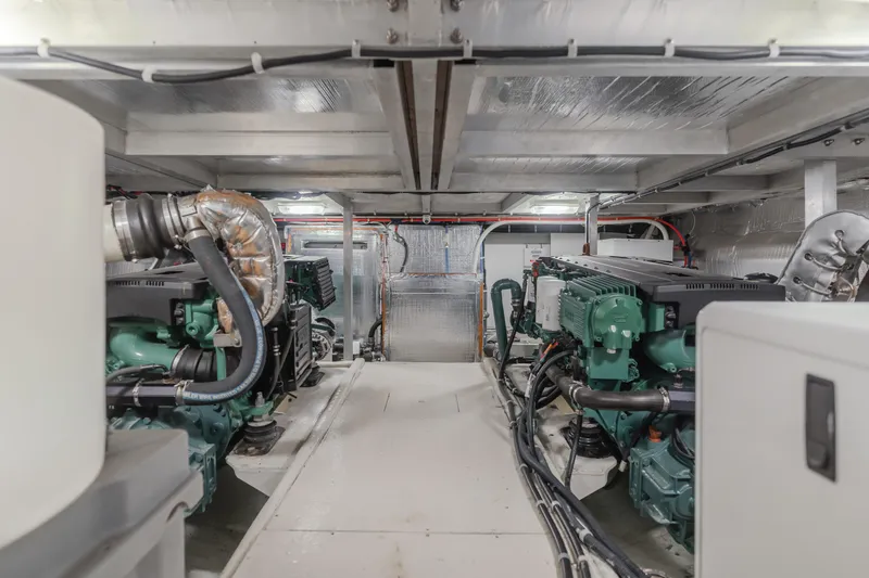 Slide: The Image of Engine room of a 2007 Navigator Pilothouse yacht, featuring dual engines and metallic insulation. - 37