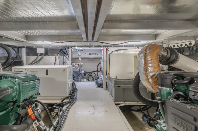 Slide: The Image of Engine room of a 2007 Navigator Pilothouse yacht, featuring machinery and equipment. - 38