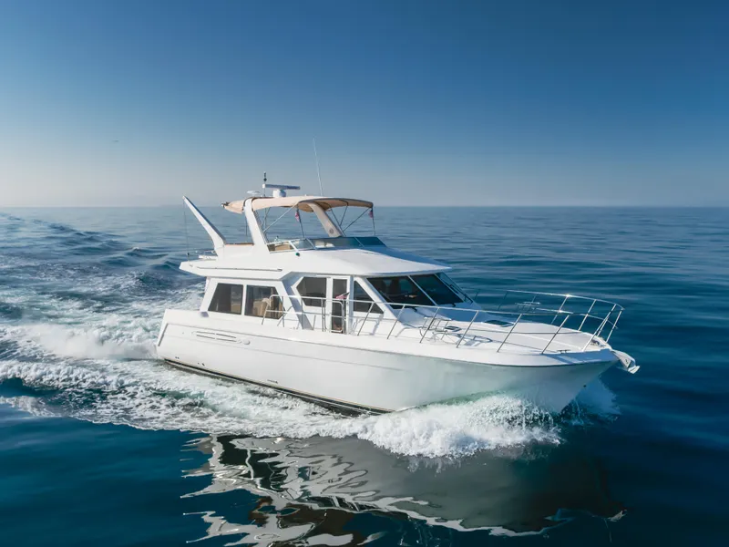 Slide: The Image of 2007 Navigator Pilothouse yacht cruising on open sea under clear blue sky. - 9