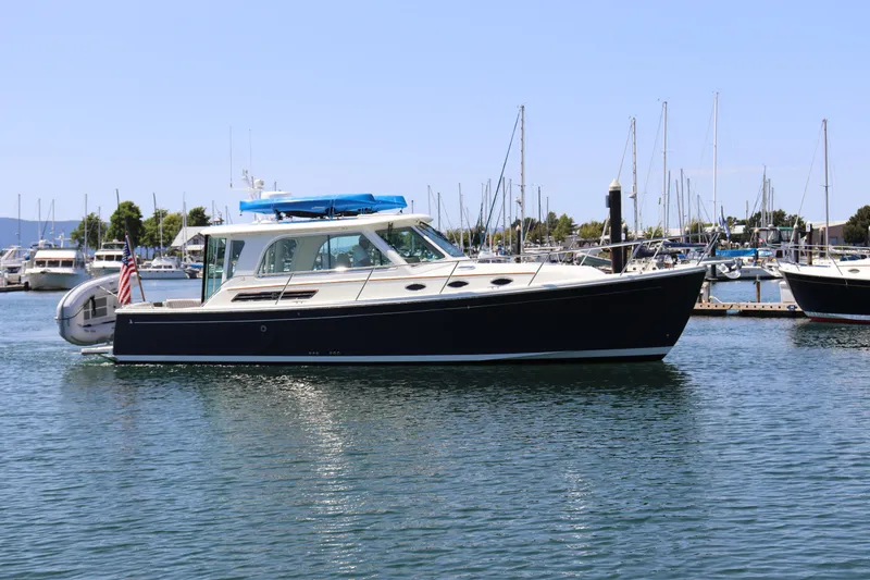 Slide: The Image of 2020 Back Cove 37 boat docked in marina, calm water, clear sky. - 0