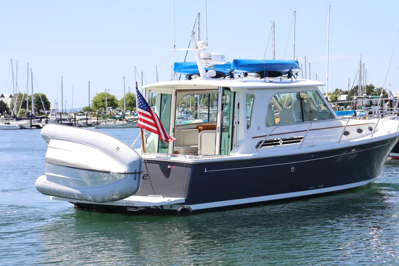 Slide: The Image of 2020 Back Cove 37 yacht with American flag, docked in marina. - 1