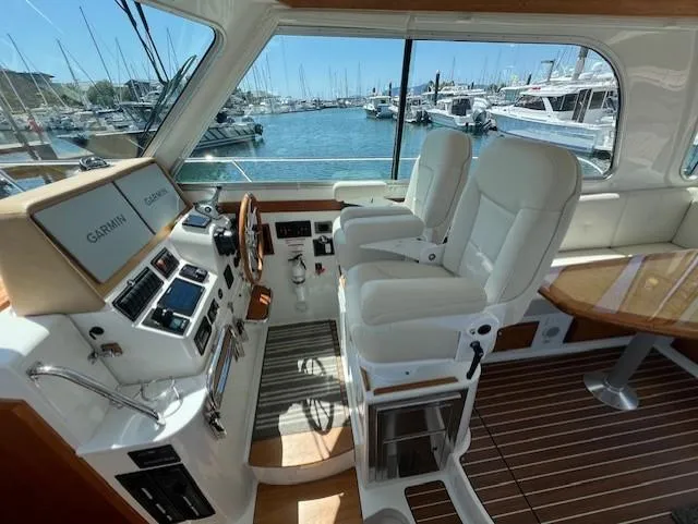 Slide: The Image of Helm of 2020 Back Cove 37 yacht with dual seats and marina view. - 10