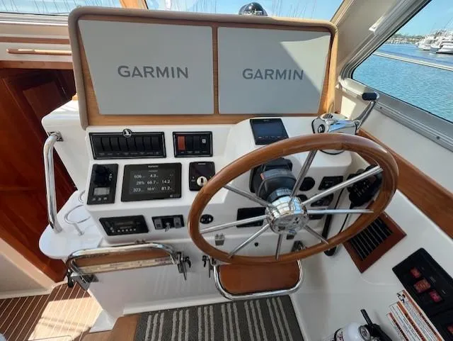 Slide: The Image of Helm of 2020 Back Cove 37 boat with Garmin navigation displays and wooden steering wheel. - 11