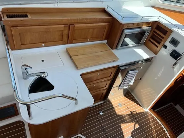 Slide: The Image of 2020 Back Cove 37 yacht kitchen with wooden cabinetry, sink, and appliances. - 13