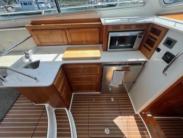 Slide: The Image of Modern kitchen on 2020 Back Cove 37 yacht with wood cabinetry and appliances. - 14