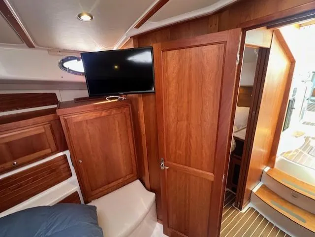 Slide: The Image of Interior of 2020 Back Cove 37 yacht with wood paneling and mounted TV. - 17