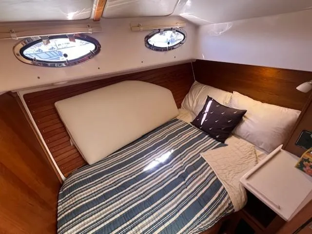 Slide: The Image of Cozy cabin interior of 2020 Back Cove 37 yacht with striped bedding and porthole windows. - 18