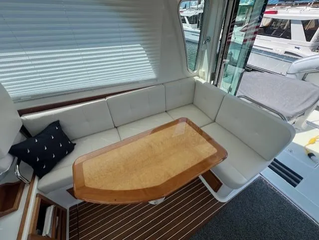 Slide: The Image of Luxurious seating area on a 2020 Back Cove 37 yacht with elegant wooden table. - 7