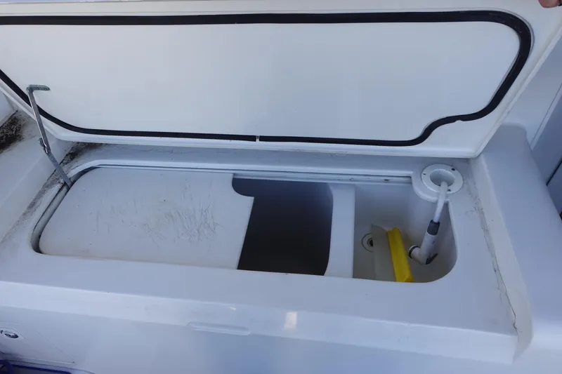 Slide: The Image of Open storage compartment on 2001 Luhrs 36 Convertible boat, showing interior details. - 13